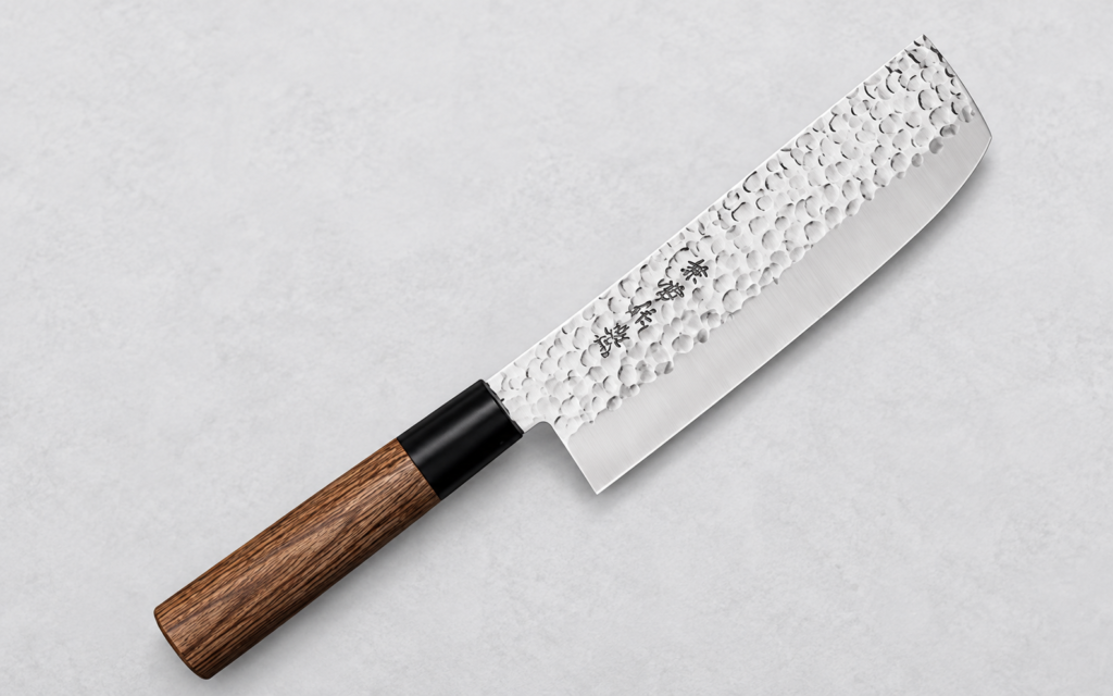 Japanese tsuchime Damascus nakiri knife with a wooden handle on a clean neutral background