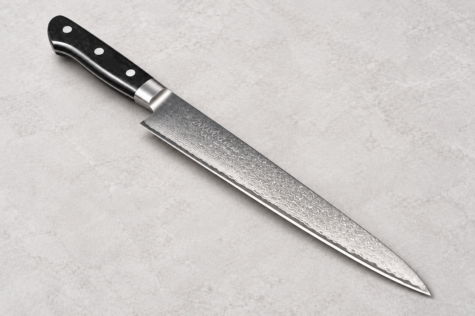 Sujihiki Japanese slicing knife with a long Damascus-patterned blade and black handle on a light gray stone background.